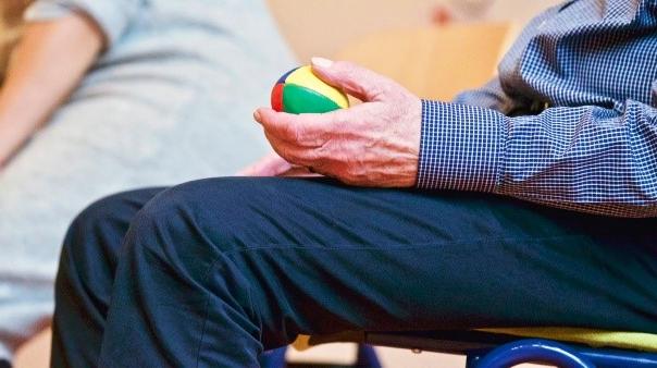 Person squeezing a ball with hand.